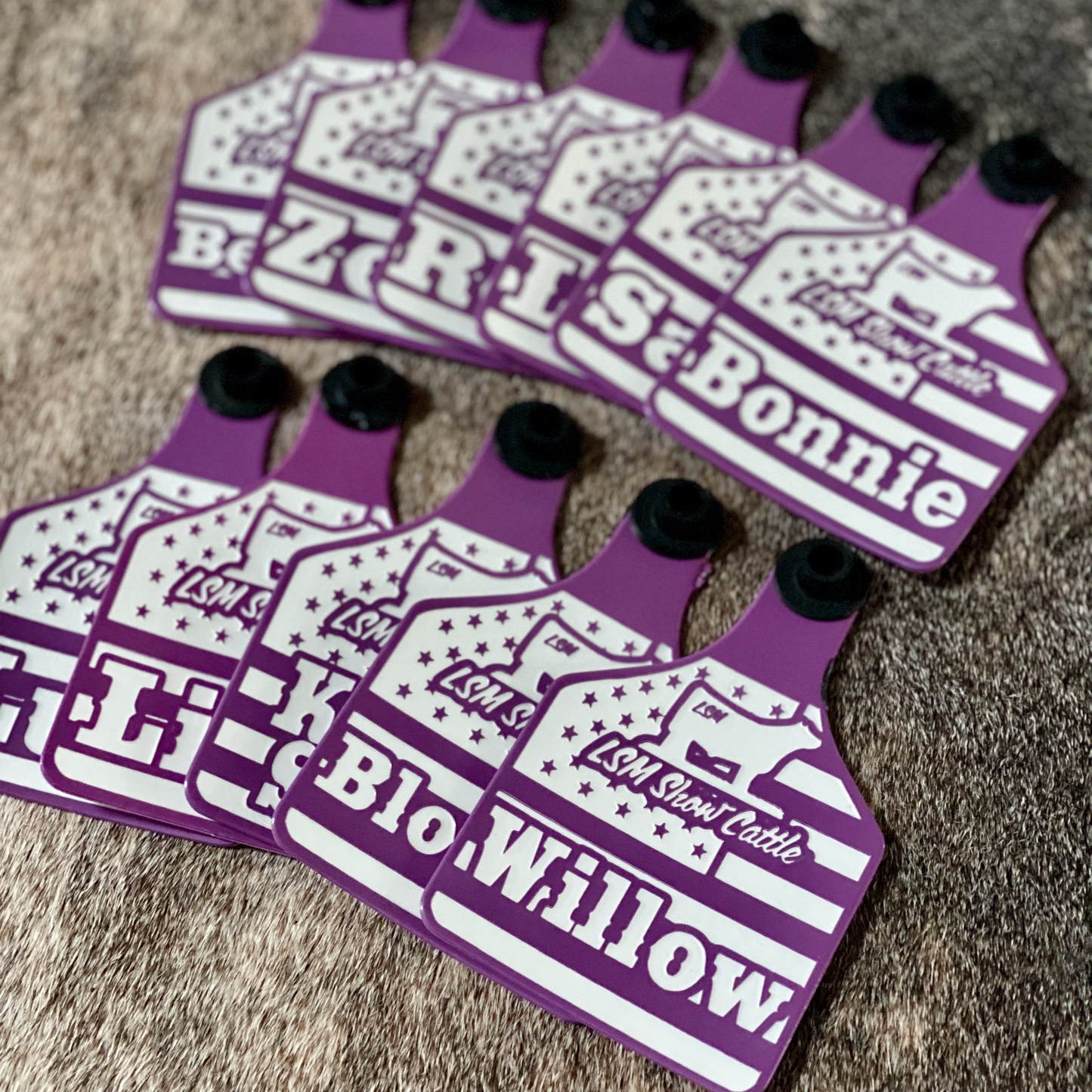 Custom laser-engraved cattle ear tag featuring durable Ritchey material with deep, long-lasting engraving. Includes Y-Tex button for secure attachment. Easy identification, weather resistance, and personalization with names, numbers, or ranch logos.