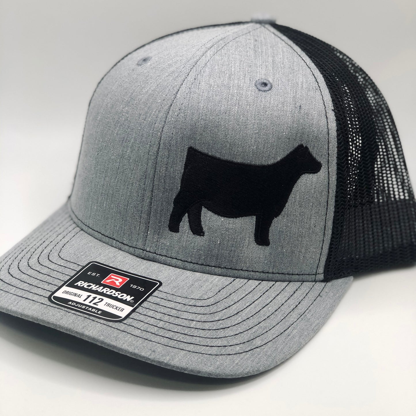 Embroidered Angus heifer hat featuring a detailed Angus cattle design on the front. Stylish and durable, perfect for livestock exhibitors, ranchers, and cattle enthusiasts. Adjustable fit for comfort and everyday wear.