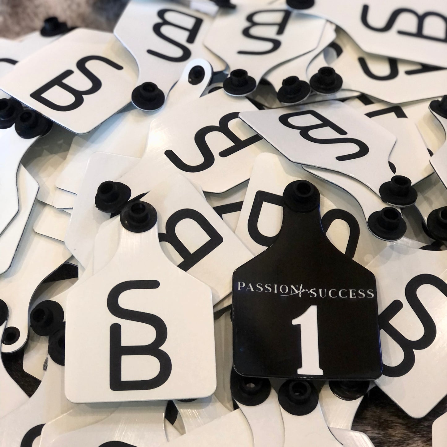 Custom laser-engraved cattle ear tag featuring durable Ritchey material with deep, long-lasting engraving. Includes Y-Tex button for secure attachment. Easy identification, weather resistance, and personalization with names, numbers, or ranch logos.