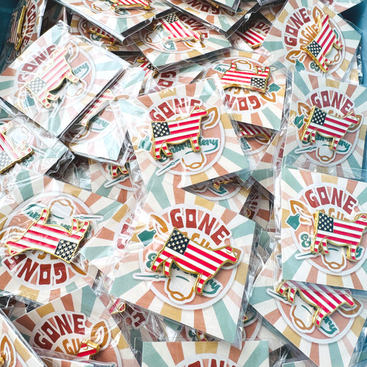 Collection of American flag patterned show heifer enamel pins.