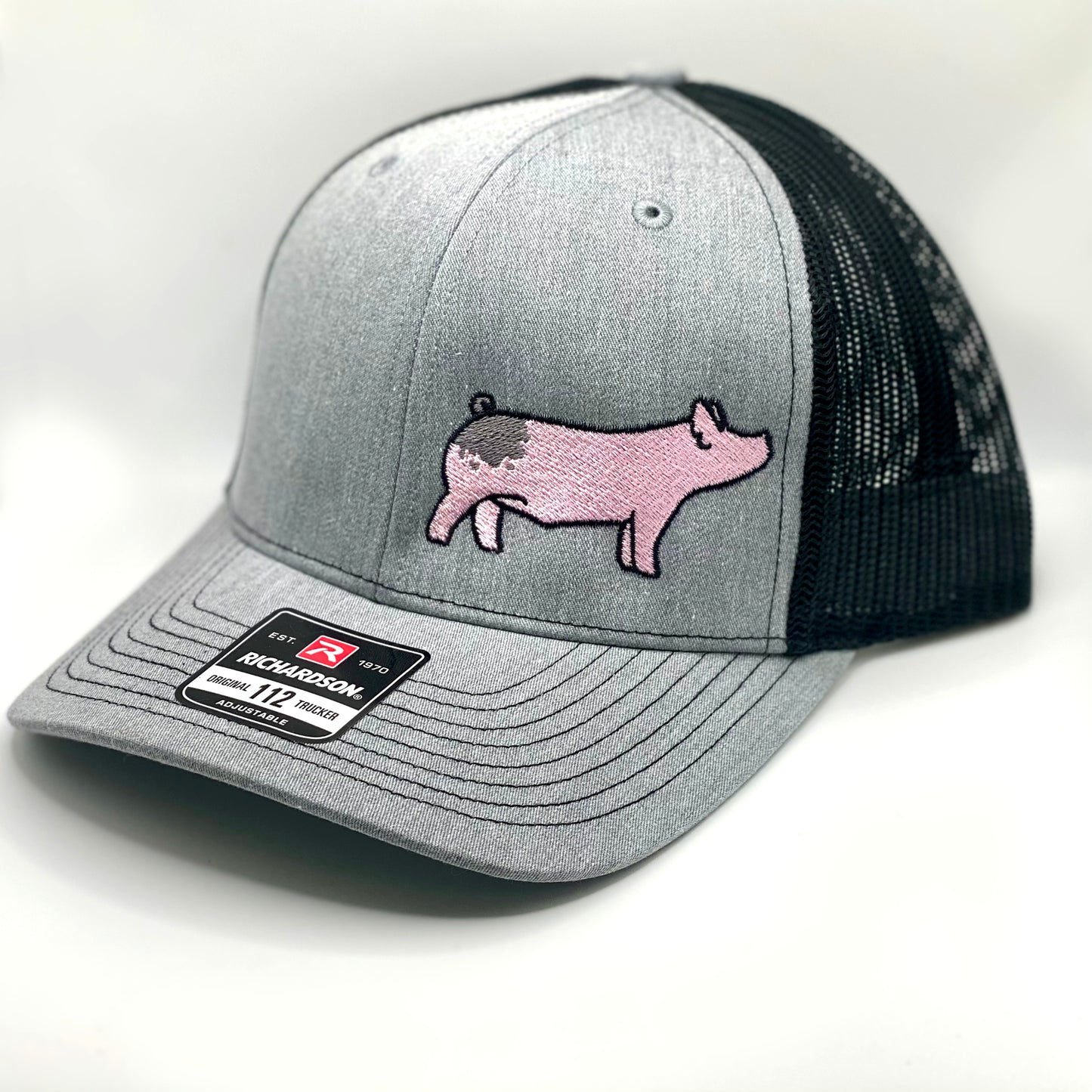 Richardson 112 hat featuring high quality embroidery of a blue butt show pig.