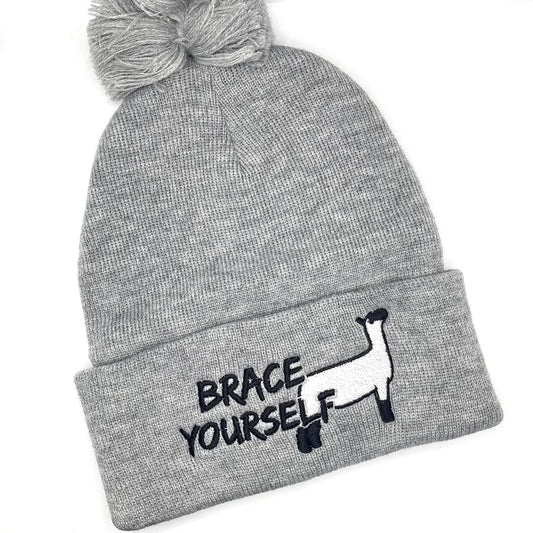 Winter hat with show lamb embroidery that reads "Brace Yourself", a funny livestock pun.