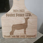 Wooden ear tag with engraved text and dog silhouette, featuring 'Foster Fence LTD.' and 'Thank you for your support!'.