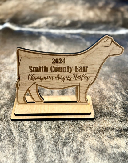 A custom engraved stand-up livestock show award, perfect for honoring Grand Champions, Reserve Champions, and outstanding exhibitors. Features detailed engraving on a durable material, ideal for display on a desk, shelf, or awards case.