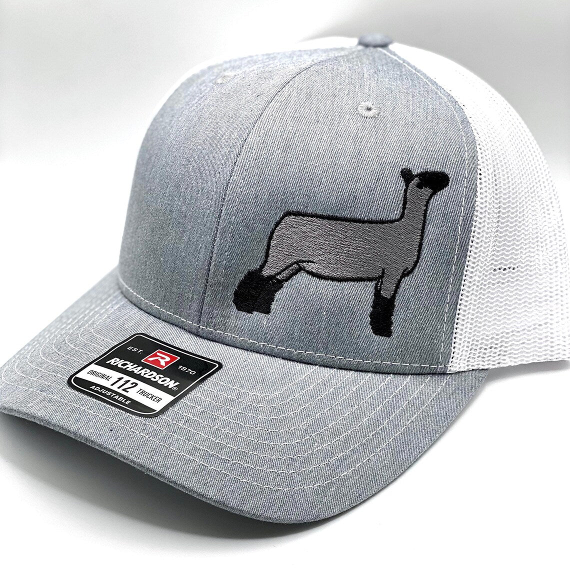 Richardson 112 trucker hat featuring an embroidered natural sheep design, available in multiple colors with a breathable mesh back and adjustable snapback closure.
