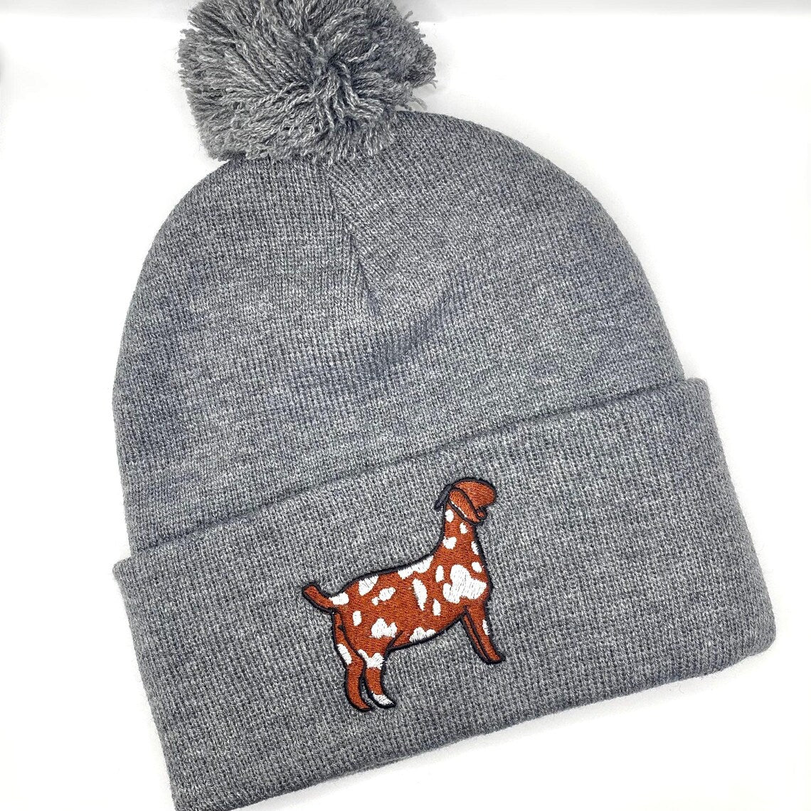 Winter hat featuring high quality embroidery of a spotted Boer show goat. 