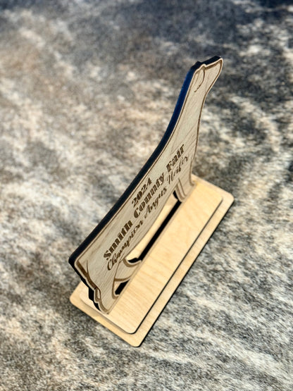 A custom engraved stand-up livestock show award, perfect for honoring Grand Champions, Reserve Champions, and outstanding exhibitors. Features detailed engraving on a durable material, ideal for display on a desk, shelf, or awards case.