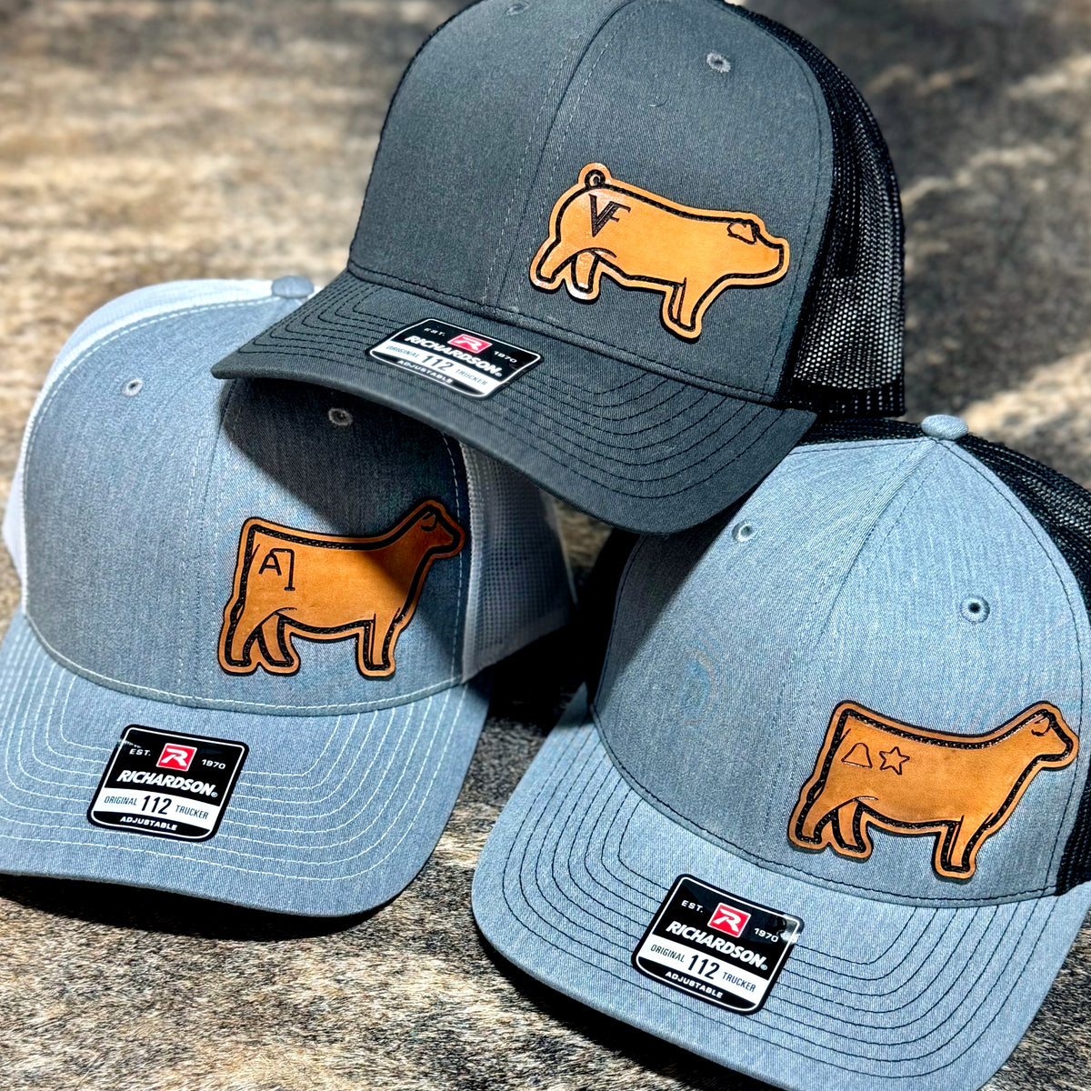 Three hats featuring various livestock patches with brands, made of genuine leather.