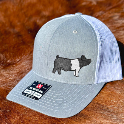Grey and white cap featuring detailed embroidery of a Hampshire show pig.