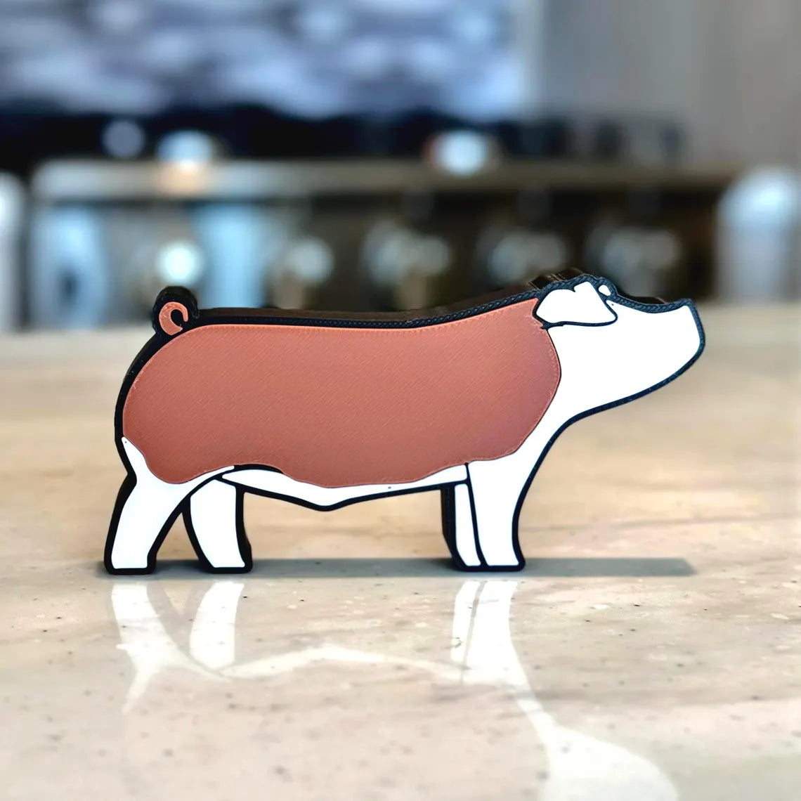 A 3D printed figure of a Hereford show pig.