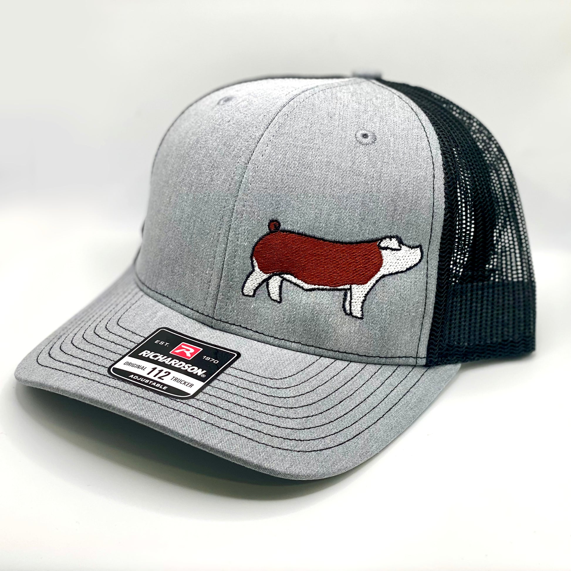 Custom embroidered Richardson 112 trucker hat featuring a high quality embroidered design on a Hereford show pig.