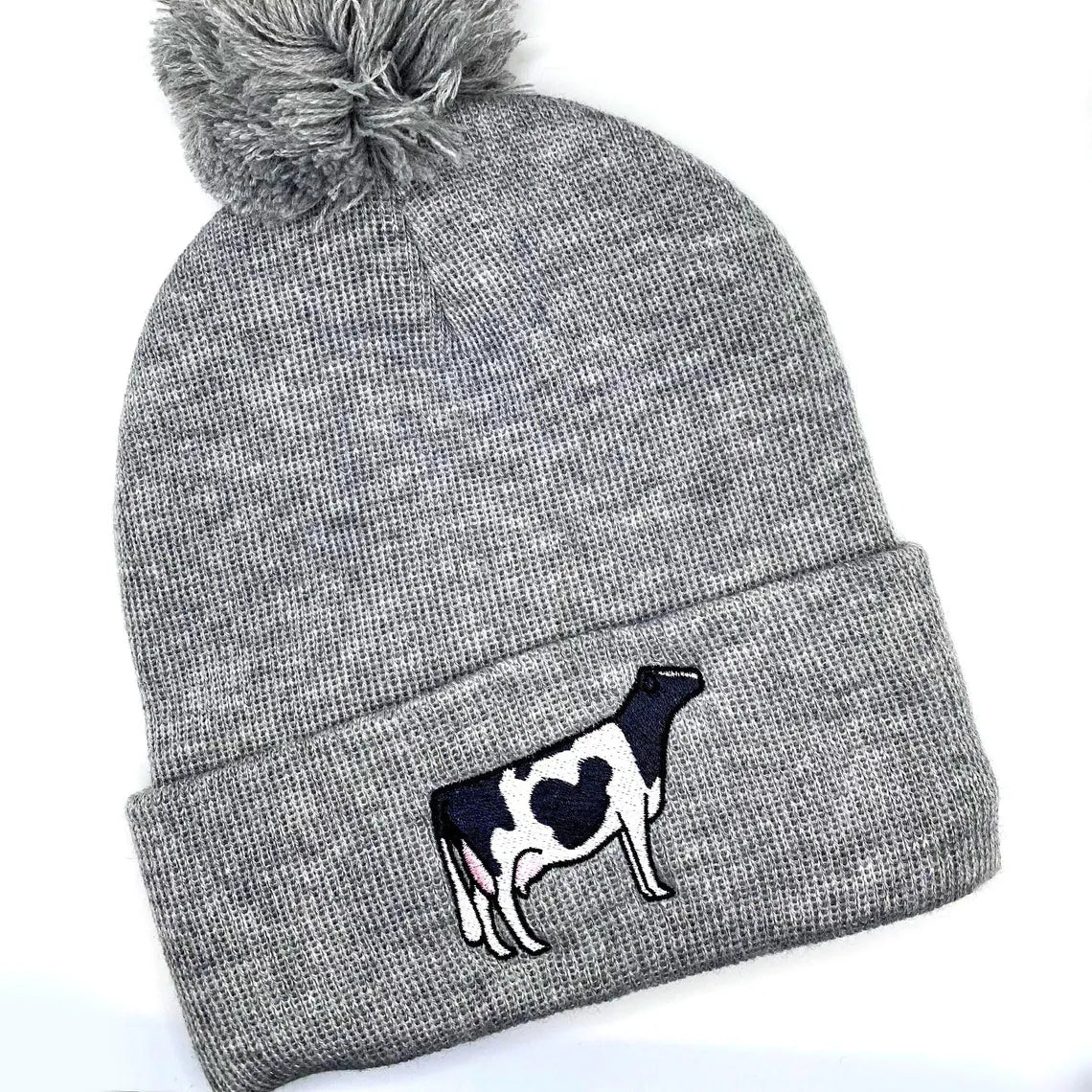 Comfy winter beanie hat featuring high quality embroidery of a Holstein dairy cow.