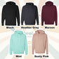 Five hoodies in black, heather grey, maroon, mint, and dusty pink on a neutral background.