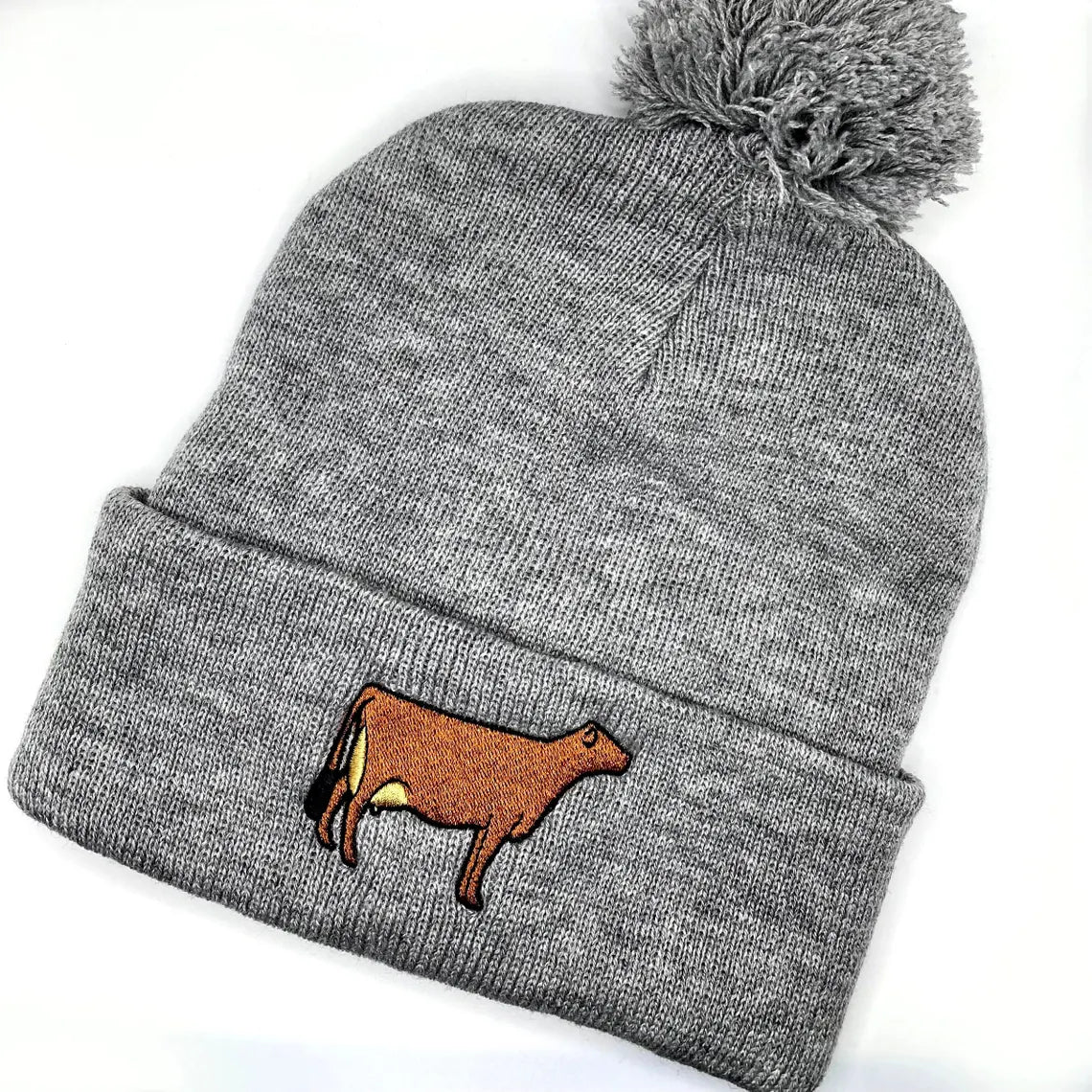 Winter hat featuring high quality embroidery of a Jersey cow, perfect for dairy farmers and cow lovers.
