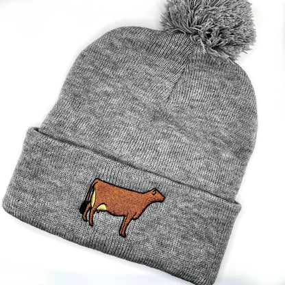 Winter hat featuring high quality embroidery of a Jersey cow, perfect for dairy farmers and cow lovers.