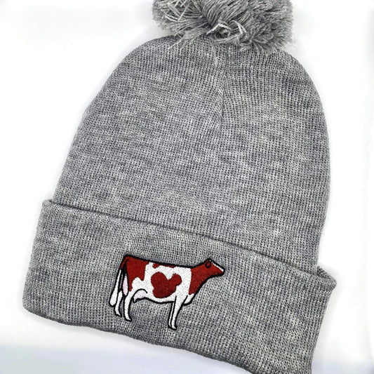 Comfy winter beanie hat featuring high quality embroidery of a Holstein dairy cow.
