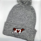 Comfy winter beanie hat featuring high quality embroidery of a Holstein dairy cow.