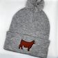 Comfy winter beanie hat with high quality embroidery of a red Simmental heifer with a blaze face.