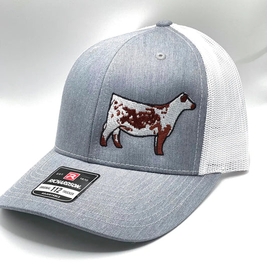Red and white trucker hat with a red Speckle Park embroidered on the front. The hat has a Richardson 112 logo on the side.