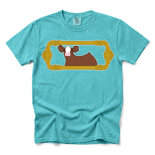 Turquoise Comfort Colors t-shirt featuring a graphic of a red and white Simmental show calf in a vintage picture frame.