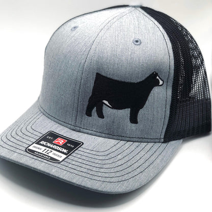 Close-up of Simmental cattle embroidery on a trucker hat, showcasing high-quality stitching and durable fabric for farm and casual wear