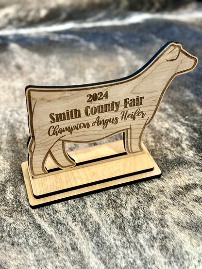 A custom engraved stand-up livestock show award, perfect for honoring Grand Champions, Reserve Champions, and outstanding exhibitors. Features detailed engraving on a durable material, ideal for display on a desk, shelf, or awards case.
