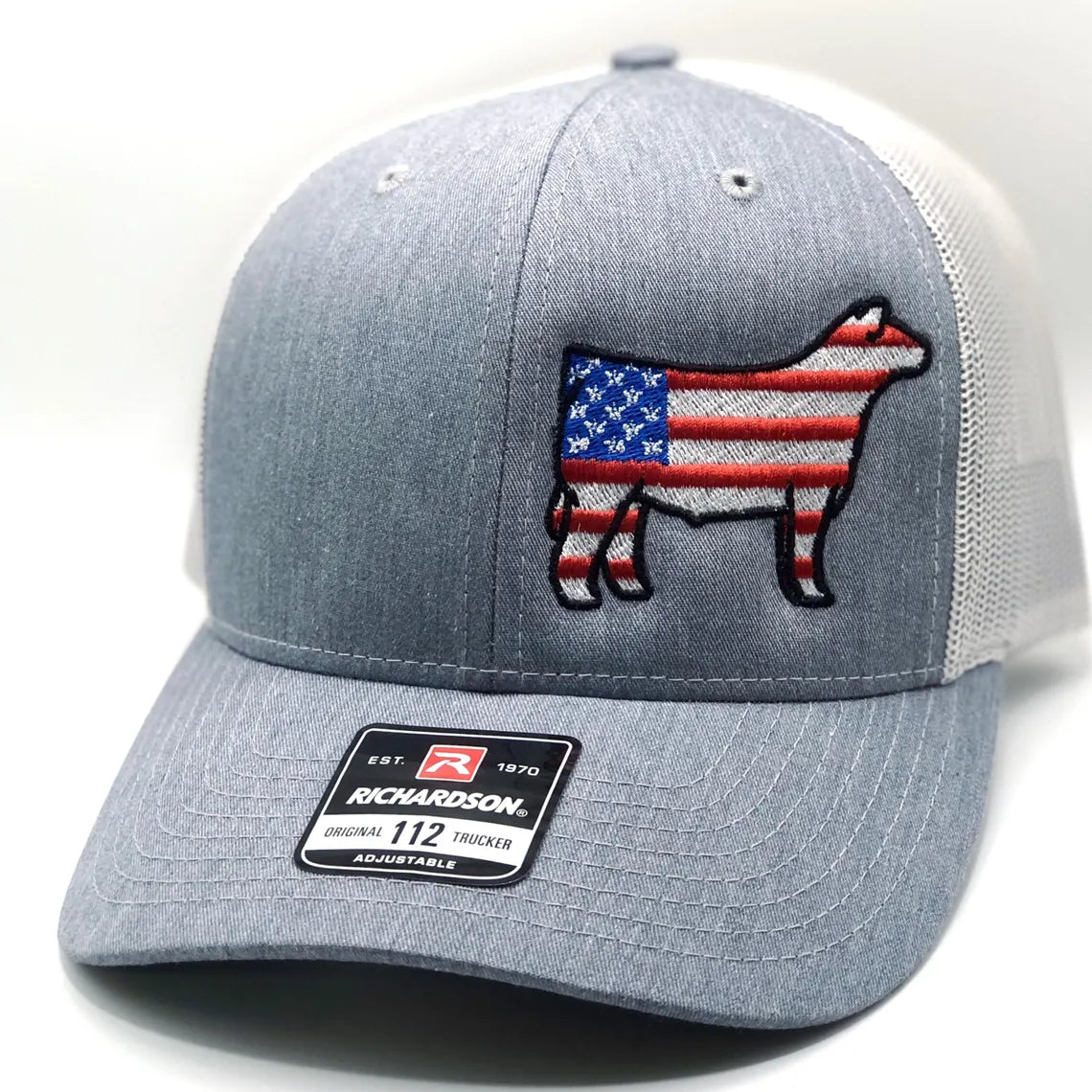Gray trucker hat with American flag cow design on a white background