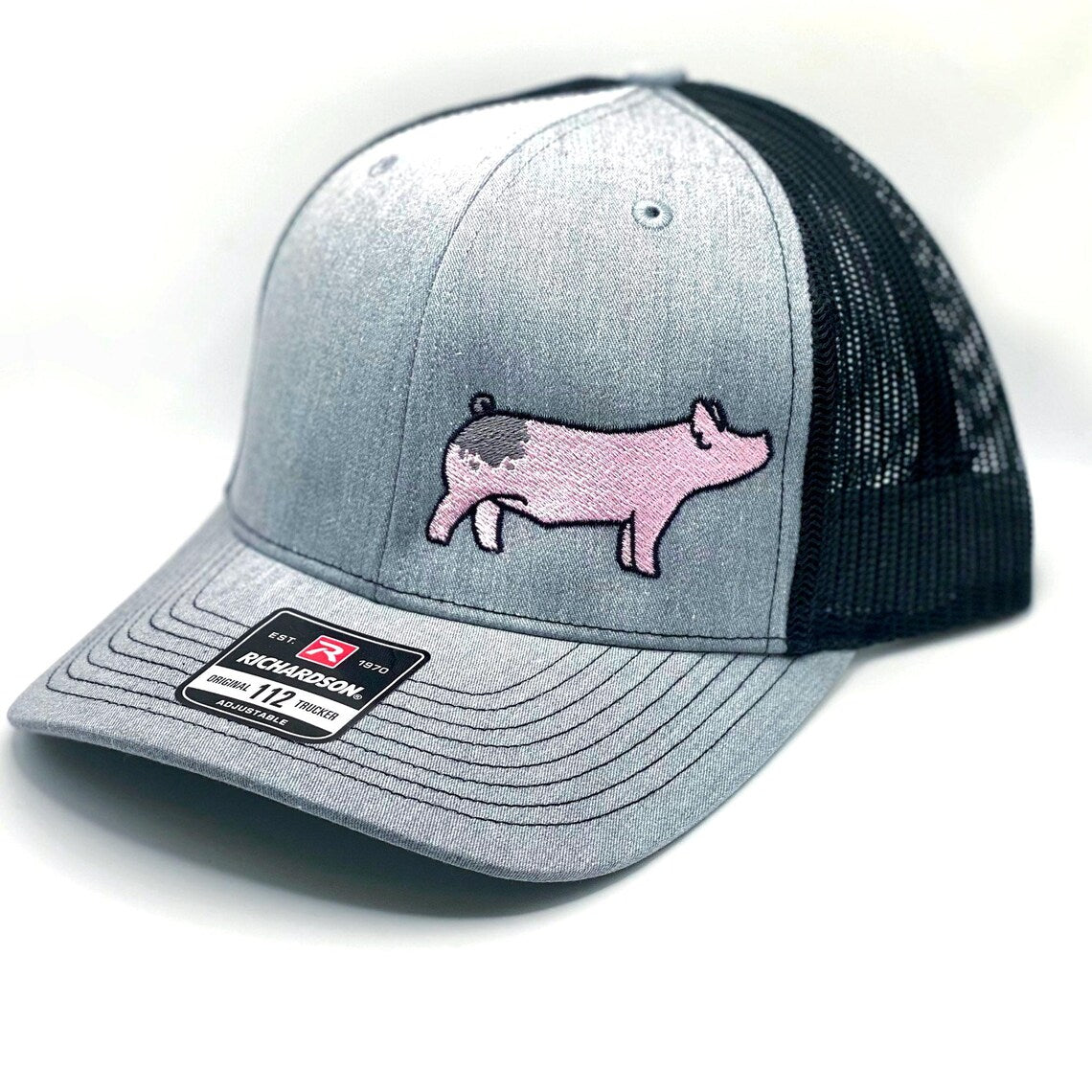 Richardson 112 hat featuring high quality embroidery of a blue butt show pig.