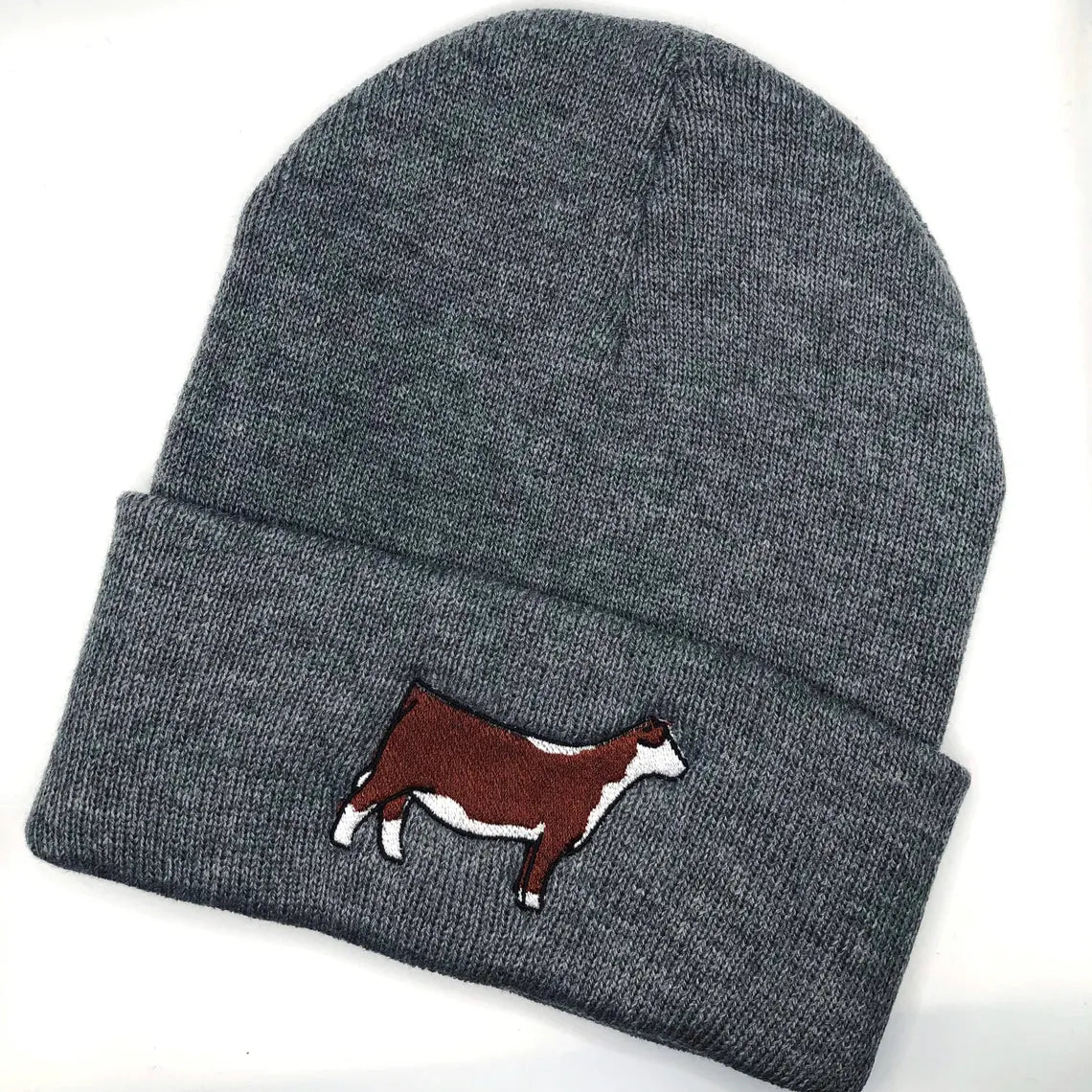 beanie with an embroidered Hereford heifer design, ideal for cattle breeders and showmen. This cozy hat keeps you warm during farm chores or show days. Perfect for showcasing your love for Hereford cattle and adding a fun touch to your wardrobe.