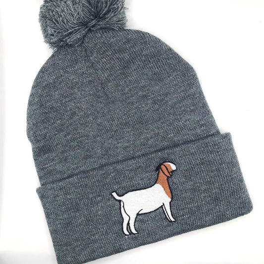 A cozy beanie featuring an embroidered design of a show goat. Made from soft, stretchy fabric for comfort and warmth, perfect for livestock enthusiasts. Ideal for cold mornings at the barn, farm shows, or casual everyday wear. Available in multiple colors.