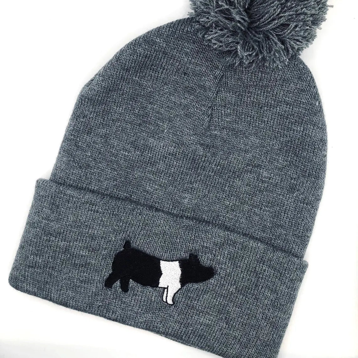 A custom embroidered beanie featuring a detailed design of a market hog. Made from high-quality materials, this hat offers warmth and comfort. It's available in various sizes, making it a perfect fit for livestock enthusiasts, especially those involved in pig shows or farming. The hat is ideal for casual wear or showcasing your love for livestock.