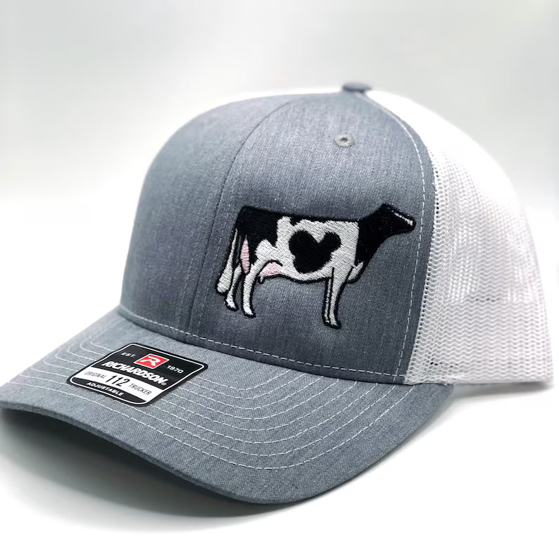 Embroidered Holstein dairy cow design on a trucker cap with breathable mesh and adjustable fit. Perfect for farmers, dairy enthusiasts, and cow lovers, combining style and comfort for everyday wear or farm life.
