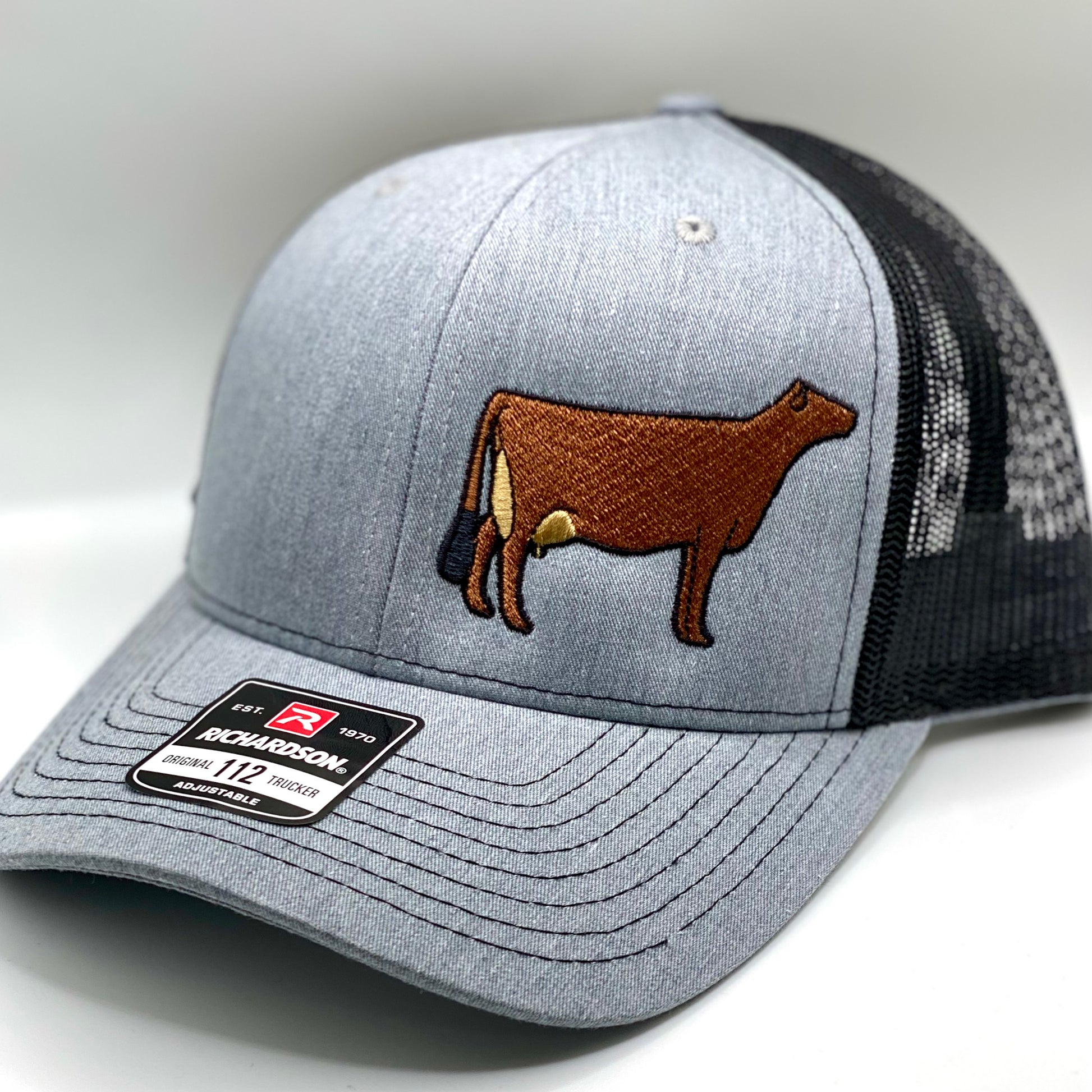 Embroidered Jersey cow design on a trucker cap with breathable mesh and adjustable fit. Ideal for dairy enthusiasts, farmers, or anyone who loves Jersey cattle. Perfect for casual wear or show events, offering comfort and style.