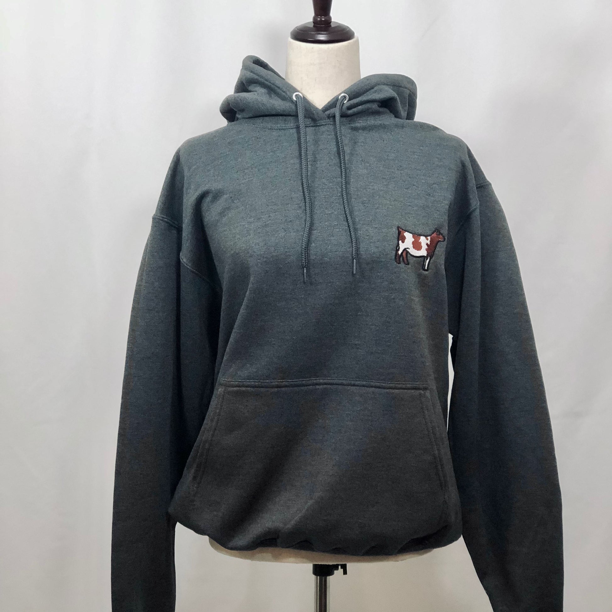 A cozy, embroidered livestock hoodie featuring a detailed design of your chosen breed—cattle, sheep, pigs, or goats. Made from soft, durable fabric, this hooded sweatshirt is perfect for chilly mornings in the barn, show day prep, or everyday wear.