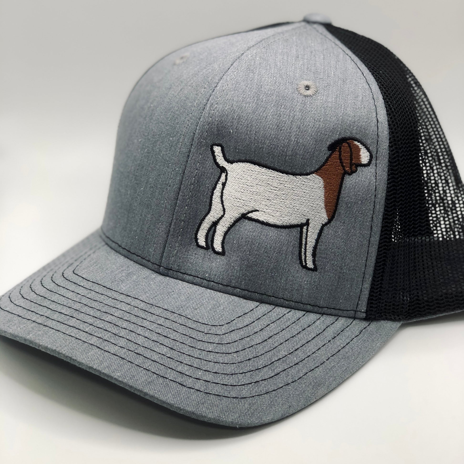 Embroidered goat design on a trucker hat with breathable mesh and an adjustable fit. Perfect for goat lovers, farmers, and showmen. A stylish, comfortable cap ideal for everyday wear or for showing off your goat pride at the barn.