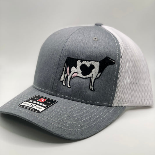 Embroidered Holstein dairy cow design on a trucker cap with breathable mesh and adjustable fit. Perfect for farmers, dairy enthusiasts, and cow lovers, combining style and comfort for everyday wear or farm life.