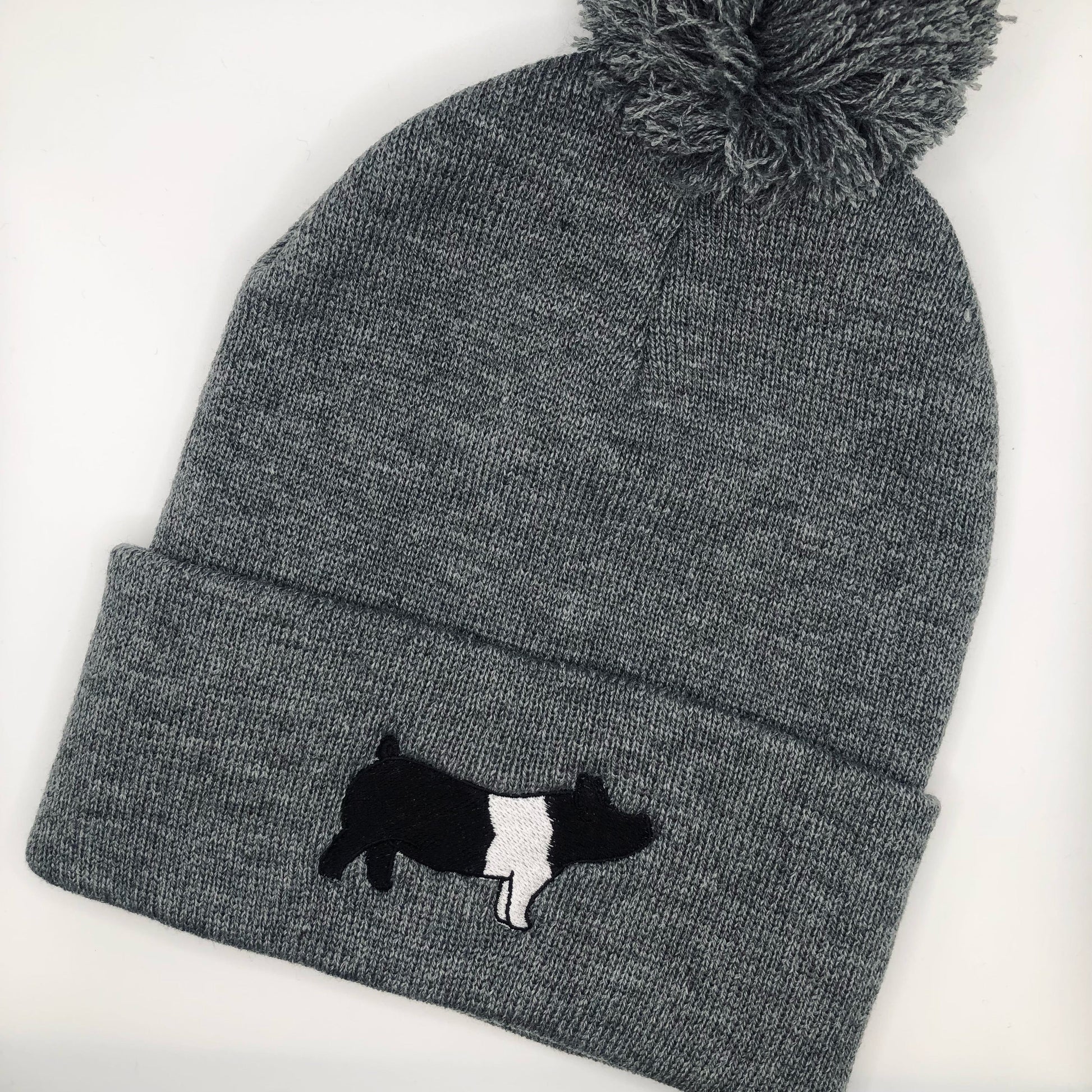 A custom embroidered beanie featuring a detailed design of a market hog. Made from high-quality materials, this hat offers warmth and comfort. It's available in various sizes, making it a perfect fit for livestock enthusiasts, especially those involved in pig shows or farming. The hat is ideal for casual wear or showcasing your love for livestock.